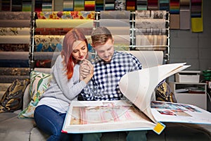 Couple choosing textile at home decoration store, shop. Making of home interior design during quarantine