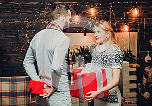Couple with christmas gift. Surprise for sweetheart. Merry christmas and happy new year. Man with gift box surprise for