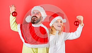 Couple christmas santa costume hold ornament ball. Christmas decoration tradition. Woman and bearded man in santa hat