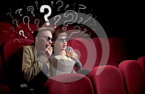 Couple in cinema with questions