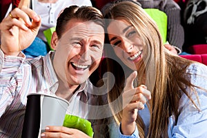 Couple in cinema theater with popcorn