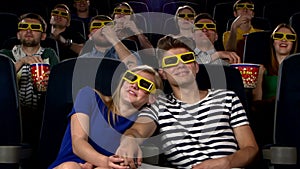 Couple in cinema watching a movie with 3D glasses