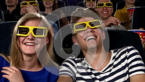 Couple in cinema watching a movie with 3D glasses