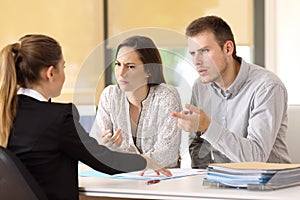 Couple claiming to a businesswoman at office