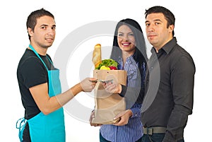 Couple and clerk at grocery