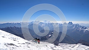 Couple of Climbers in crampons coming up to the summit of Elbrus in Caucasus mountains. Snow peak.