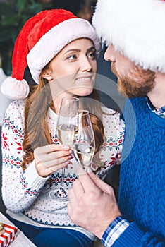 Couple clinking champagne glasses on christmas