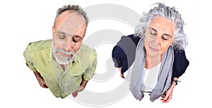 Couple with closed eyes on white