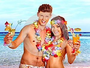 Couple with cocktail at Hawaii wreath beach