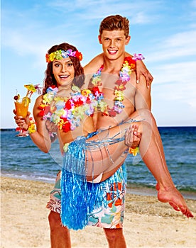 Couple with cocktail at Hawaii wreath beach