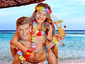 Couple with cocktail at Hawaii wreath beach