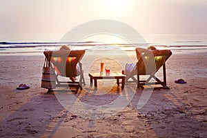 Couple with cocktails relaxing on the beach