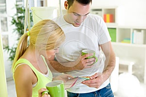 Couple on coffee break with samples of paint colors