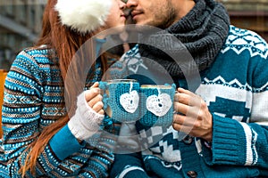 Couple with coffee cups in winter