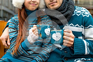 Couple with coffee cups in winter