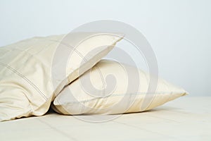 Couple comfortable soft yellow pillows on bed