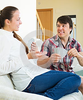 Couple communicate while playing cards