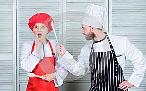 Couple compete in culinary arts. Kitchen rules. Culinary battle concept. Woman and bearded man culinary show competitors