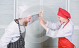 Couple compete in culinary arts. Kitchen rules. Who cook better. Culinary battle concept. Woman and bearded man culinary
