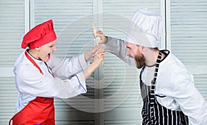 Couple compete in culinary arts. Kitchen rules. Who cook better. Culinary battle concept. Woman and bearded man culinary