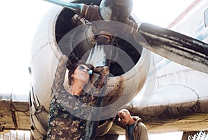 Couple concept. Couple pose at retro plane. Couple of sensual woman and handsome man at aircraft. Couple in love