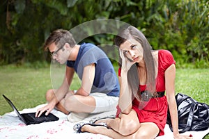 Couple, conflict and frustrated woman on disaster picnic date with distracted man on laptop in forest. Crisis, fail and