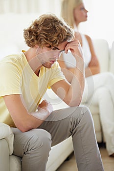 Couple conflict, stress and divorce fight on a sofa with argument, anxiety or cheating depression in their home