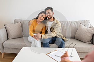 Couple consulting with lady professional, enjoying results