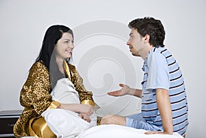 Couple conversation on bed