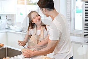 Couple cooking bakery in kitchen room, Young asian man and woman together