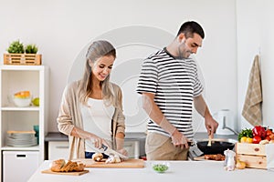 Couple cooking food at home kitchen