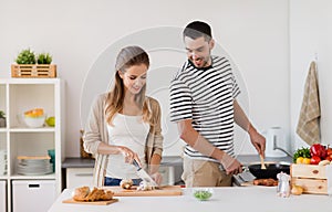 Couple cooking food at home kitchen