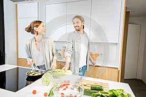 Couple cooking food at the kitchen home
