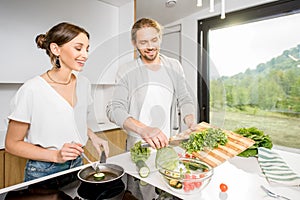 Couple cooking food at the kitchen home