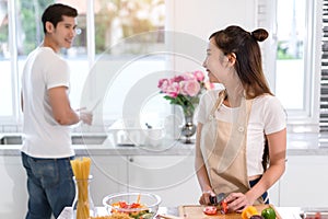 Couple cooking food in kitchen room, Young Asian man and woman together