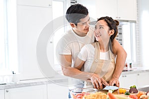 Couple cooking food in kitchen room, Young Asian man and woman together