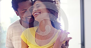 Couple cooking, preparing a meal and having fun together while bonding, talking and flirting in a home kitchen. Smiling