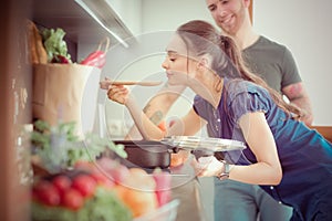 Couple cooking together in their kitchen at home