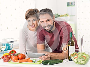 Couple cooking together and using a tablet