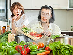 Couple cooking veggy lunch