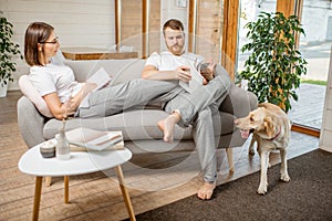 Couple on the couch with dog at home