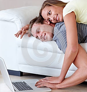 Couple, couch and laptop for movie in home, scroll and relax together for bonding, love and care. Man, woman and lying