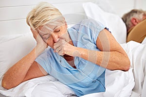 Couple, coughing or sick old woman in bed with husband or man with flu virus, tuberculosis or health problem. Chest pain