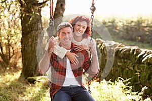 Couple with country garden swing