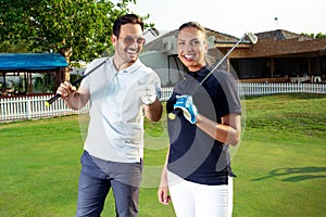 Couple at the course playing golf and looking happy