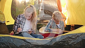 Couple creative teenagers stay in summer camp tent