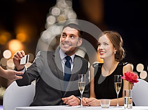 Couple with credit card at christmas restaurant