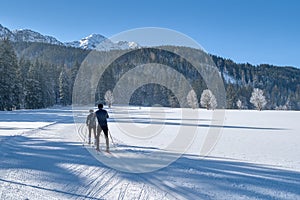 Couple cross-country skiing in beautiful nordic winter landscape in Leogang, Tirol, Alps, Austria