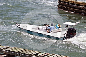 Sleek Open Fishing Skiff Powered By One Outboard Engine photo