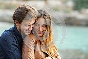 Couple cuddling affectionate on the beach